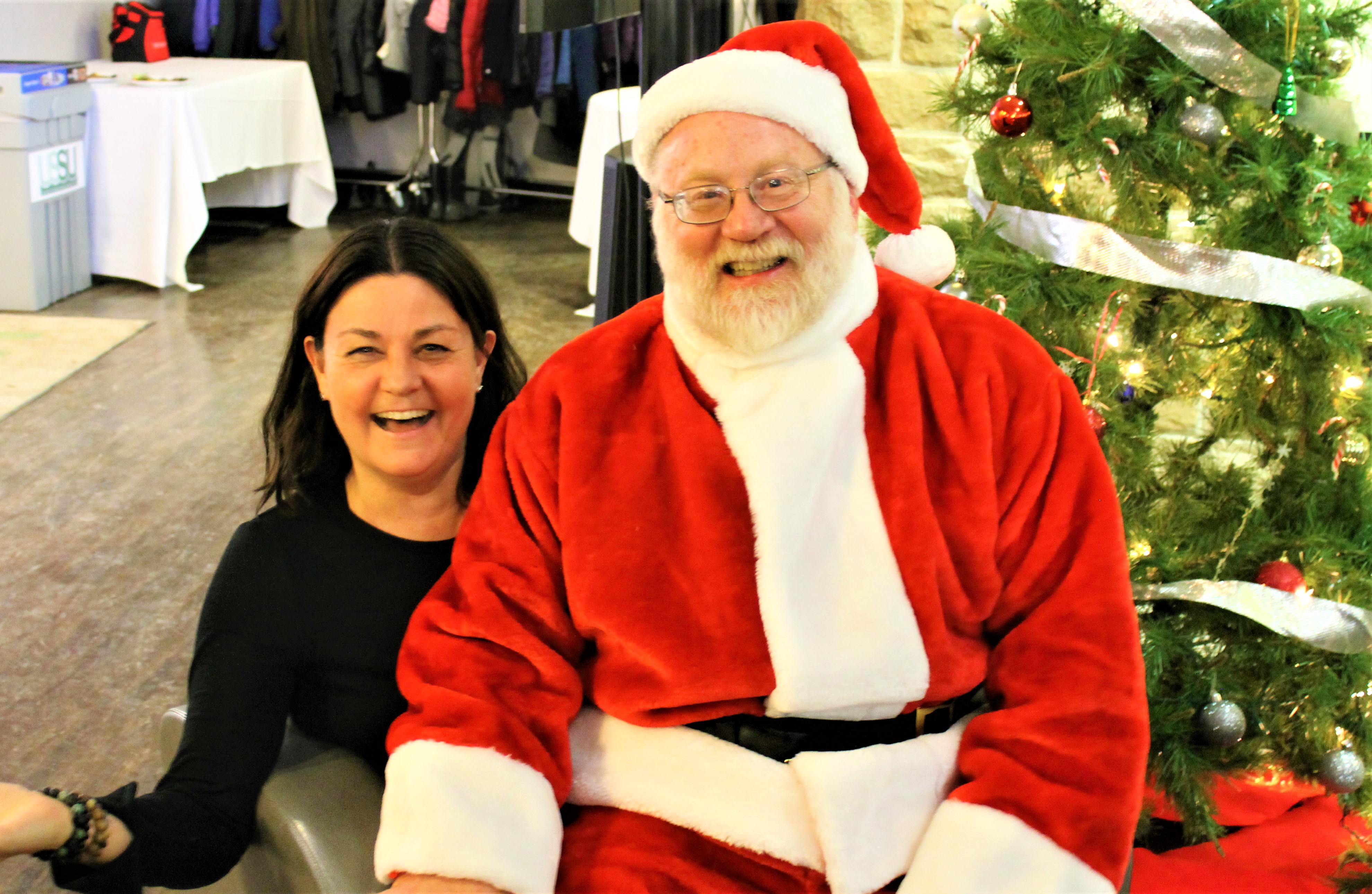 SENS Executive Director Irena Creed with Santa Claus. Photo by Victoria Schramm.